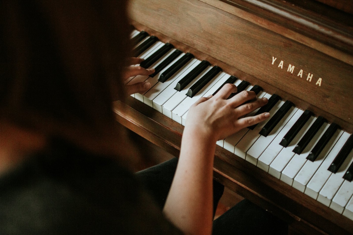 Hands on a piano keyboard